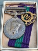 A General Service Medal with Malaya Clasp to Lt. C P B Parry RAMC with associated cap badge