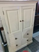 A modern white painted pine cupboard with 4 lower drawers