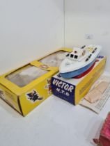 A Sutcliffe Victor clockwork M.T.B. boat, boxed with instructions and key and a Pelham Puppet Pinocc