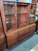 A 1980s Ercol wall unit having three central drawers, with glazed cupboard above, 155cms