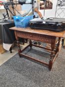 An antique oak side table having one drawer on turned legs with lower stretcher, 97cms