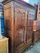 A French antique walnut 2 door wardrobe having one long drawer, the interior shelved, 152cm