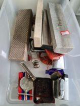 A box containing Parker pens, Zippo lighters, medals and seals, etc