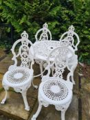 A cast metal (aluminium) table and chair set with ornate bow and swag design
