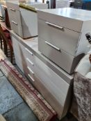 A large modern chest having 4 long drawers and a pair of similar 2 drawer bedside chests. The large