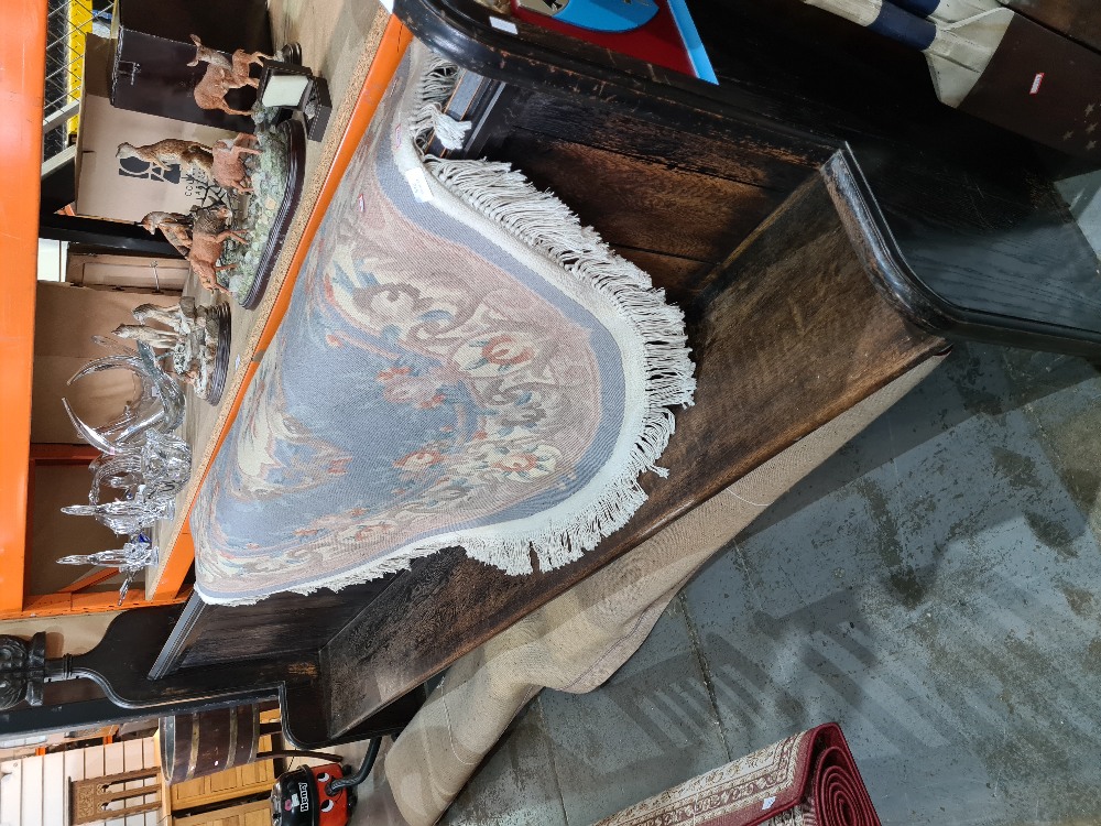 An old dark stained oak Church pew having shaped ends with painted plaques and rear prayer shelves,