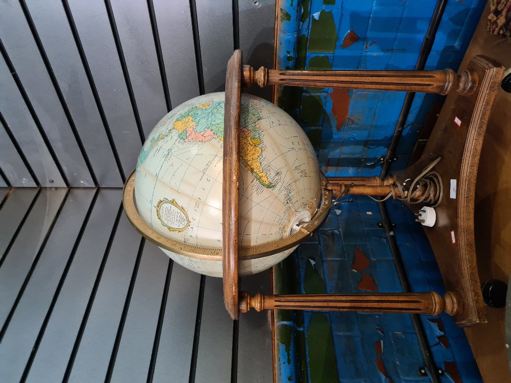A reproduction illuminated globe on wooden stand, height 78cms