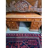 A late Victorian oak twin pedestal desk having nine drawers, 121.5cms