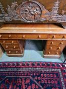 A late Victorian oak twin pedestal desk having nine drawers, 121.5cms