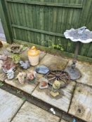 A pedestal mounted bird bath and a selection of concrete animal figures and a glazed stoneware jug