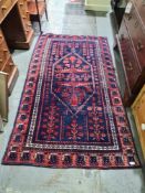 An Afghan rug having central motif with geometric border, 193 x 105cms
