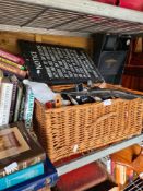 A wicker basket containing a selection of collectables including costume jewellery, belt buckles, sc