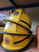 Two West Sussex Fire Brigade helmets and a Somerset example