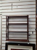 A mahogany shelf with bobbin and cross frame side supports