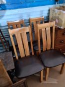 Four modern Oak dining chairs, with faux leather chocolate coloured seats