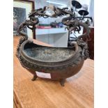 An Oriental metal oval bowl having bronze dragon handle with glass ball, 22cm