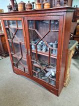 An early 20th Century stained pine bookcase having pair of glazed doors, 128cms