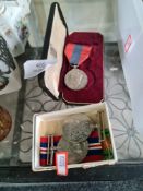 A pair of World War II medals and a cased faithfull service medals