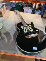 An Ozark Professional guitar inlaid with butterflies
