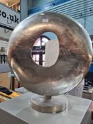 A modern metalwork circular sculpture with central hole, 64cm