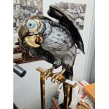 A decorative metal parrot on perch
