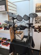 A Roland Electronic drum kit (percussion sound module) TD -6V, with pedals and stool