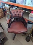 A revolving faux leather Captain's chair