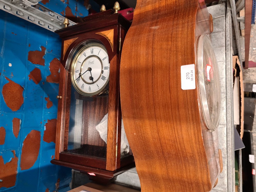 Two clocks, one being a wall the other manufactured by 'Vedette' a mantle clock