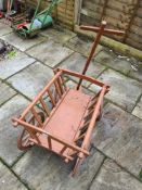 A wooden small hand cart with 4 wheels