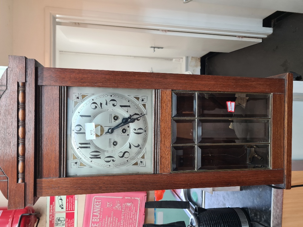 An early 20th century walnut cased wall clock