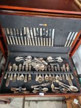 A canteen of cutlery, next of tables, bookcase, etc