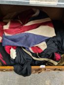 A suitcase full of vintage clothing and an old Union Jack flag, etc