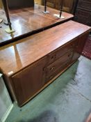 An Ercol elm sideboard having three central drawers flanked by cupboards, 156cms