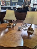 A pair of small gilt cherub table lamps on oblong marble bases