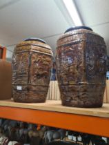 A pair of oriental style hexagonal vases having treacle glaze the panels decorated birds, animals an