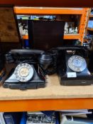 Two old Bakelite telephones, one numbered 164