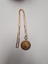 Unmarked yellow metal chain, probably 9ct gold, AF, broken link, hung with a circular pendant, locke