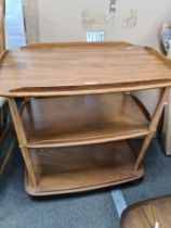 An Ercol elm three tier tea trolley, 71cms