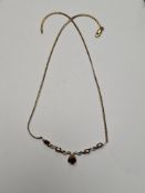 9ct yellow gold flat link necklace with a 9ct gold twist effect panel inset garnets and diamond chip