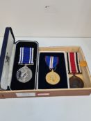 A Special Constabulary Long Service Medal to Robert Mooring, a Police Long Service Medal to Const Ri