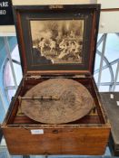 A Continental Victorian polyphon in walnut case, plays 11 inch discs, 20 in total, probably made in