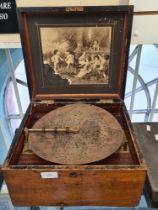 A Continental Victorian polyphon in walnut case, plays 11 inch discs, 20 in total, probably made in