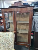 An Edwardian inlaid two door display cabinet on splay legs