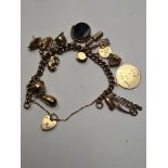 9ct yellow gold charm bracelet hung with 15 9ct gold charms to incl. Ballerina, elephant, teapot, ri
