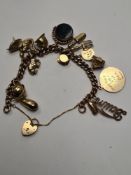 9ct yellow gold charm bracelet hung with 15 9ct gold charms to incl. Ballerina, elephant, teapot, ri