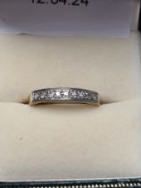 18ct yellow gold half hoop diamond ring set with 9 small brilliant cut diamonds, size O, marked 750,