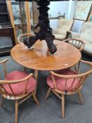 A set of four Ercol horseshoe back dining chairs and an Ercol two flap elm table