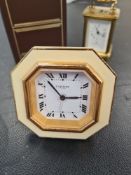 Cartier; a small easel travel clock having cream border and a miniature Matthew Norman carriage cloc