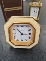 Cartier; a small easel travel clock having cream border and a miniature Matthew Norman carriage cloc