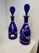 A pair of Georgian style Bristol Blue decanters having white and gilt decoration